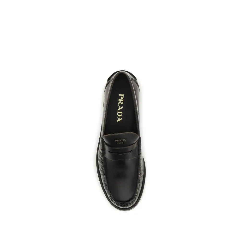 Prada black calf leather Bos Taurus slip-on loafers with polished finish