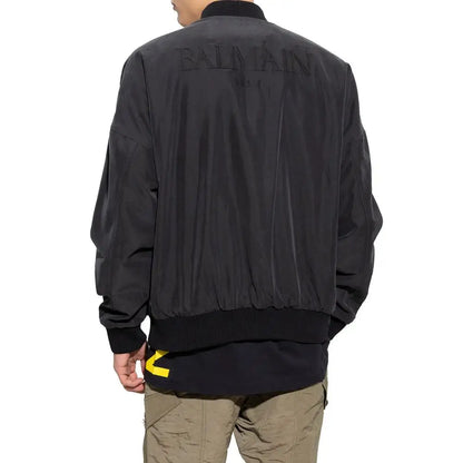 Balmain black cotton bomber jacket med sort bomulds, subtile præget branding og fed gul logo ved sømmen