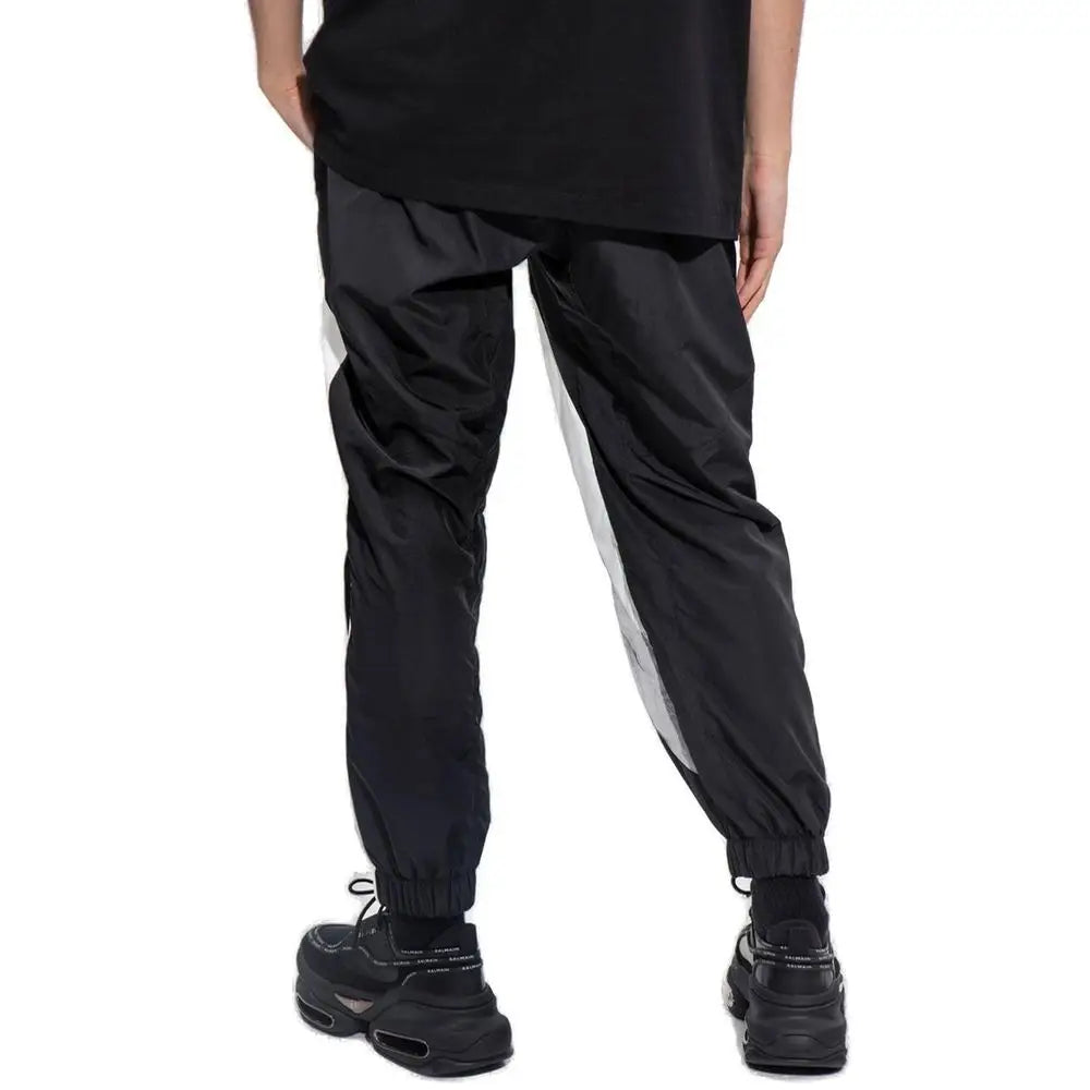 Balmain sorte polyester athletic pants med sorte joggers, hvide side striber og elastiske manchetter