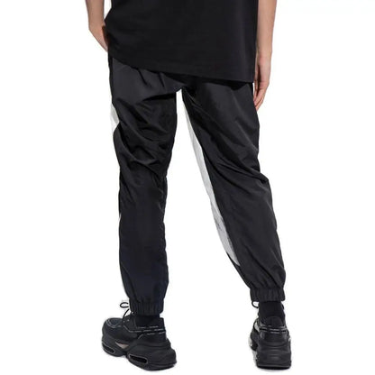 Balmain sorte polyester athletic pants med sorte joggers, hvide side striber og elastiske manchetter
