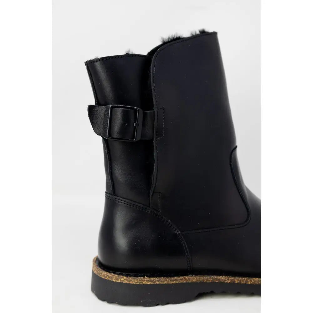Birkenstock black leather ankle boots with buckle strap and faux fur lining