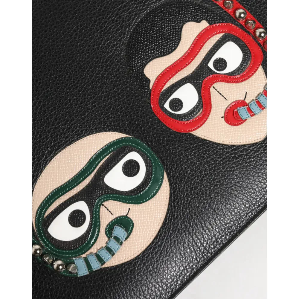 Dolce & Gabbana black leather clutch med to applikerede ansigter og sølvknopper
