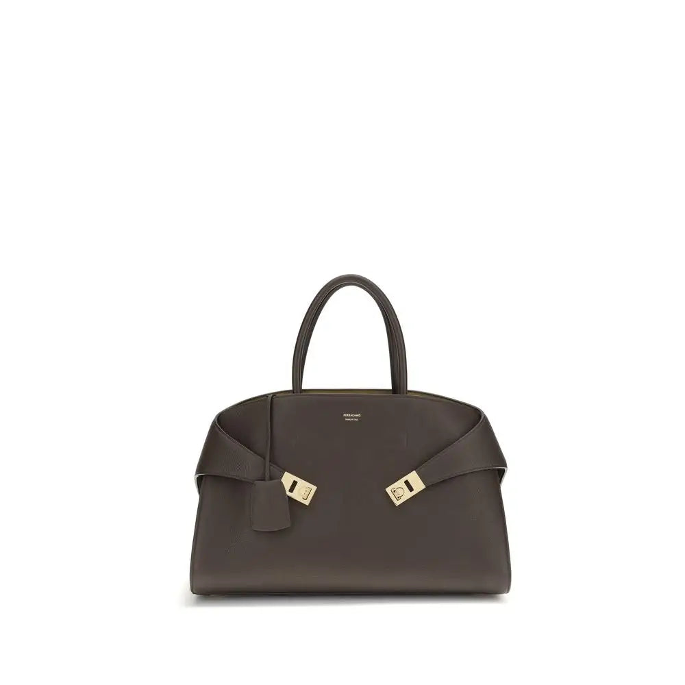 Sleek Ferragamo brown calf leather shoulder bag with gold hardware and bow strap