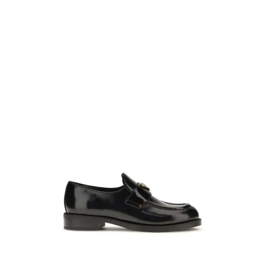 Prada black calf leather Bos Taurus slip-on loafers with patent finish and gold logo