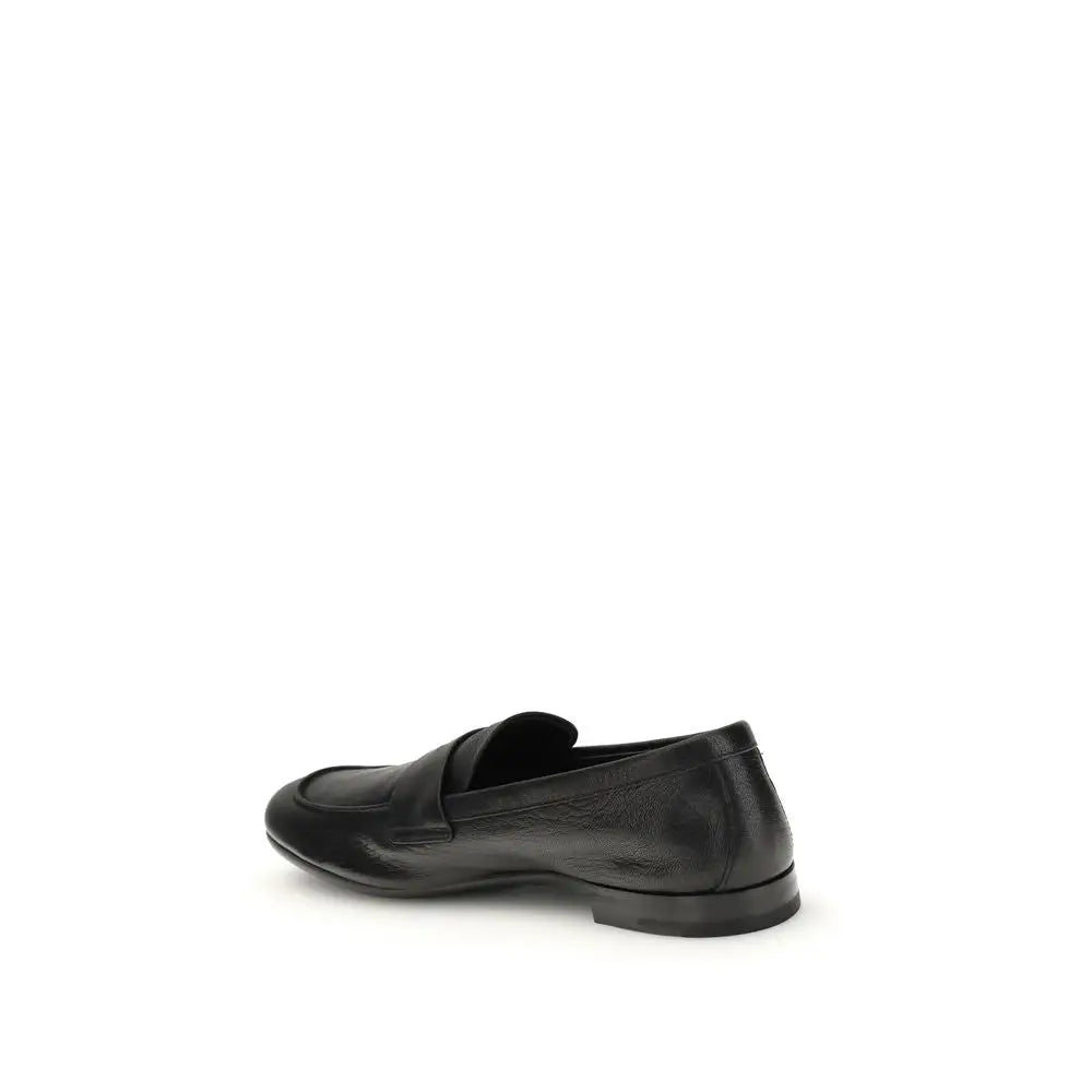 Prada black calf leather Bos Taurus slip-on loafers with sleek minimalist design