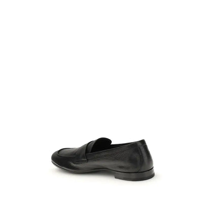 Prada black calf leather Bos Taurus slip-on loafers with sleek minimalist design