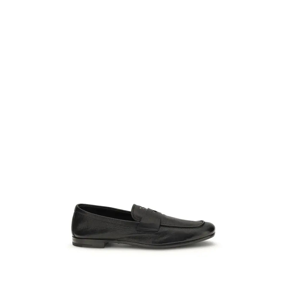 Prada black calf leather Bos Taurus slip-on loafers with sleek minimalist design and subtle sheen
