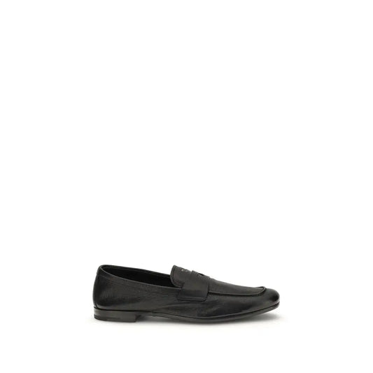 Prada black calf leather Bos Taurus slip-on loafers with sleek minimalist design and subtle sheen