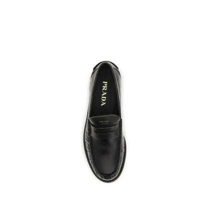 Prada black calf leather Bos Taurus slip-on loafers with polished finish
